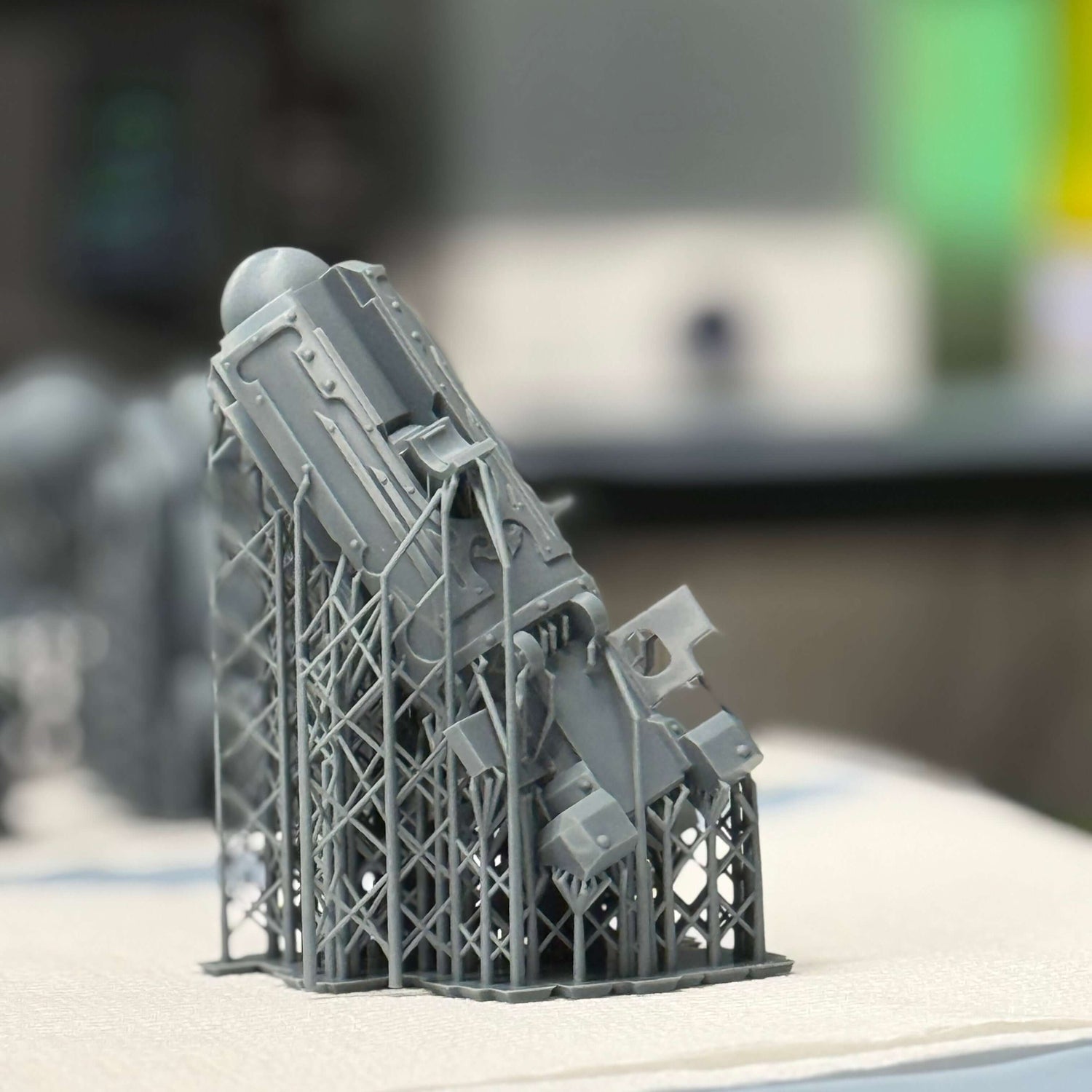 picture of a resin 3d printed leg of a titan model with the supports still attached
